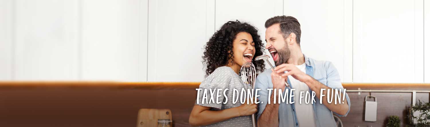 A young couple in a kitchen. The woman is singing into a whisk and the man is looking at her and singing into a ladle. Text over the image reads Taxes Done. Time for Fun!
