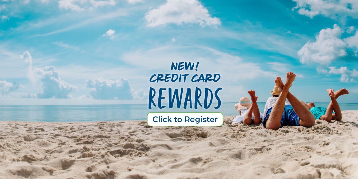 Father with daughter and son laying on their stomachs with their feet in the air on the beach looking out at the water. Text reads New! Credit card rewards. Click to register.