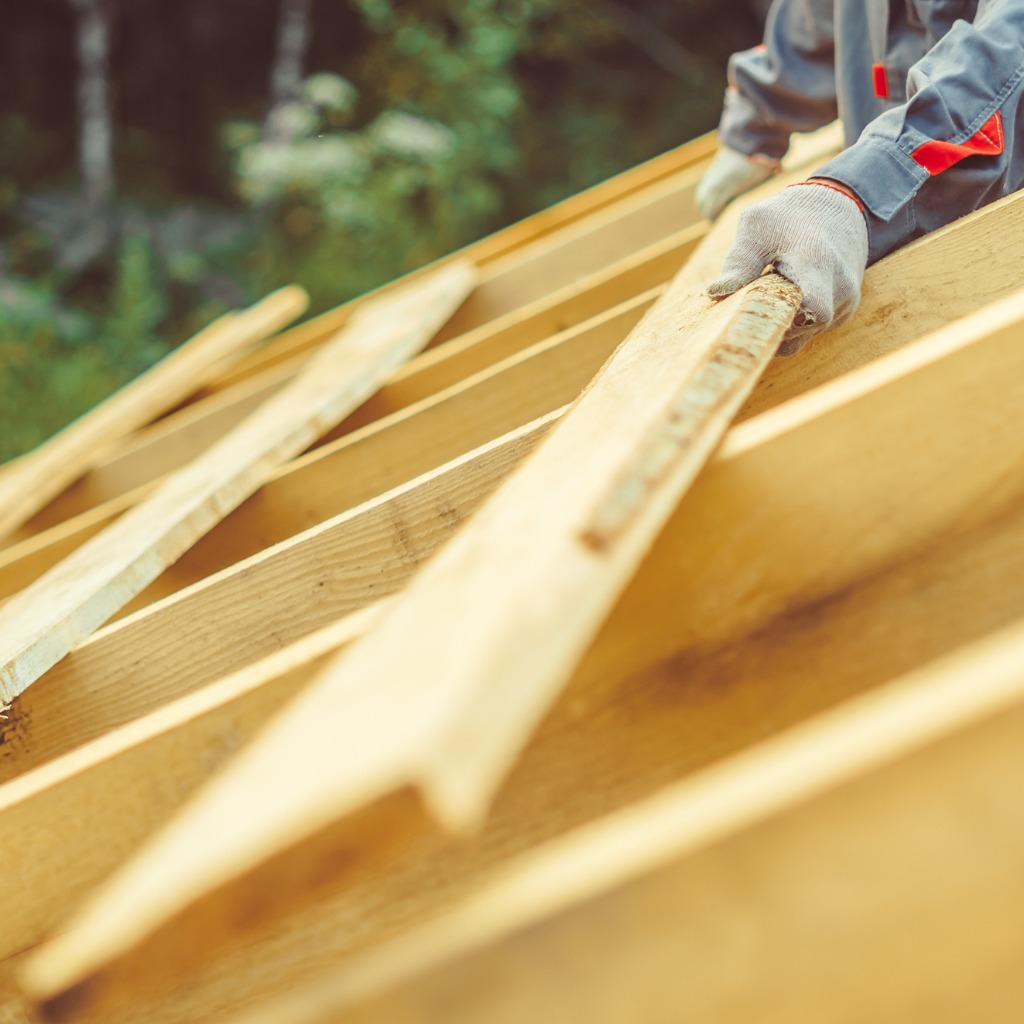 A worker building a roof