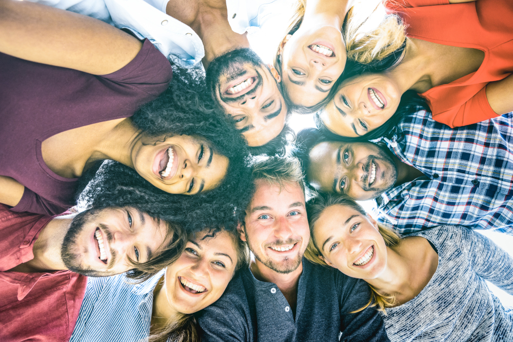 Group of diverse people look down into camera